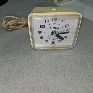 vintage cream-colored Timex electric alarm clock
